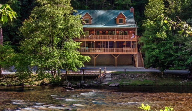 Log cabin with large decks on the Bank of the Tuckasegee River.